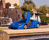 AUT 02 RK0010 07
1994 Bugatti EB110 GT Coupe Blue Door Open 3/4 Side View By Water Fountain