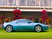 AUT 04 BK0002 01
2010 Lotus Evora Coupe Blue Profile View On Grass By Building
