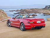 AUT 05 RK0623 01
2010 Mercedes-Benz SL500 Convertible Red 3/4 Rear View On Beach By Houses