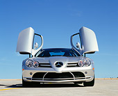 AUT 05 RK0431 01
2005 Mercedes-Benz SLR McLaren Silver Low Head On View Butterfly Doors On Pavement Blue Sky