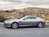 AUT 06 RK0127 01
2009 Aston Martin DB9 Silver Profile View On Pavement By Stone Wall