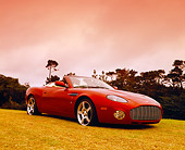 AUT 06 RK0022 02
2005 Aston Martin Zagato Roadster Burgundy 3/4 Front View On Grass By Hill