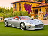 AUT 09 BK0018 01
Spyker C8 Aileron Spyder Silver 3/4 Front View On Grass By Building