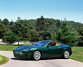 AUT 09 RK0199 02
Aston Martin Vantage Green Concept Car 3/4 Front View On Pavement By Grass And Trees Blue Sky