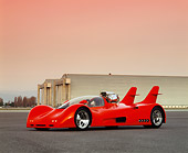 AUT 09 RK0226 02
LE-1 Ground Fighter Red 3/4 Low Side On Pavement Hanger In Background Headlights On Red Sky