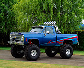 AUT 14 RK0022 05
Blue Paragon Monster Truck Blue 3/4 Side View On Pavement By Grass And Trees