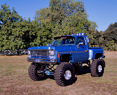 AUT 14 RK0441 01
1976 GMC 4x4 Pickup Truck Blue 3/4 Side View On Grass By Trees