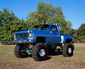 AUT 14 RK0441 02
1976 GMC 4x4 Pickup Truck Blue 3/4 Side View On Grass By Trees
