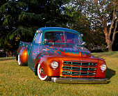 AUT 14 RK0500 03
1949 Studebaker Pick Up Green Orange Flames 3/4 Front View On Grass