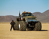 AUT 14 RK0817 01
1971 Chevrolet Monster Truck Gulf Oil Black And Gold 3/4 Front View With Driver In Desert