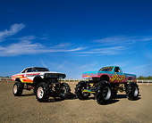 AUT 14 RK0834 09
Two Monster Trucks Trouble Maker And Wild Thing On Dirt Blue Sky