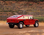 AUT 15 RK0400 09
2000 Hummer H1 Slantback Red Rear 3/4 View On Dirt By Quarry