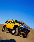 AUT 15 RK0667 03
2003 Hummer H2 Lifted Yellow Slanted Low 3/4 Front View On Dirt Hill Blue Sky