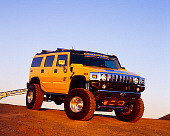 AUT 15 RK0677 03
2003 Hummer H2 Yellow 3/4 Front View On Dirt Hill Blue Sky At Dusk