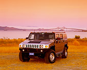 AUT 15 RK0727 04
2003 Hummer H2 Pewter Metallic 3/4 Front View On Dry Grass Water With Bridge Filtered