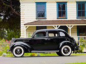 AUT 19 RK0748 01
1937 Ford Deluxe Touring Sedan Black Profile View On Pavement By House