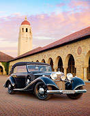 AUT 19 RK0804 01
1937 Mercedes-Benz 540K Cabriolet Black 3/4 Front View On Brick Road By Building