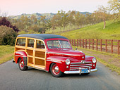 AUT 20 RK0478 01
1947 Ford Woodie Red 3/4 Front View On Pavement By Fence And Grassy Hill