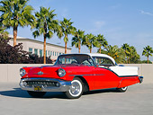 AUT 21 RK2556 01
1957 Oldsmobile 98 Coupe Red And White 3/4 Front View On Pavement By Palm Trees