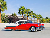AUT 21 RK2557 01
1957 Oldsmobile 98 Coupe Red And White 3/4 Front View On Pavement By Palm Trees
