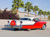 AUT 21 RK2560 01
1957 Oldsmobile 98 Coupe Red And White 3/4 Rear View On Pavement By Palm Trees