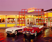 AUT 21 RK0925 07
1955 Pontiac Starchief And 1957 Corvette 3/4 Front View On Wet Pavement In Front Of Taxis At Night