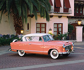 AUT 21 RK1385 03
1955 AMC Nash Rambler Country Club Pink 3/4 Side View By Spanish Building And Palm Tree