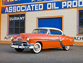 AUT 21 RK2291 01
1954 Pontiac Chieftain Orange 3/4 Front View On Pavement By Building