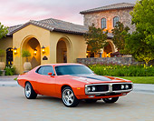 AUT 22 BK0078 01
1973 Dodge Charger 440 Magnum R/T Orange With Black Stripe 3/4 Front View On Pavement By House