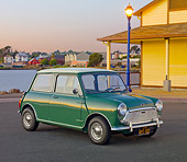 AUT 22 BK0086 01
1967 Austin Mini Cooper Mark II Green 3/4 Front View On Pavement By Water And Houses At Dusk