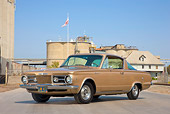 AUT 22 RK2956 01
1965 Plymouth Barracuda Gold 3/4 Front View On Pavement By Building