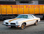 AUT 23 BK0041 01
1973 Oldsmobile Cutlass White And Gold Stripe 3/4 Front View On Gravel By Train