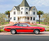 AUT 23 BK0008 01
1973 Dodge Charger SE 440 Red With Black Stripe Profile View On Pavement By House