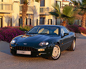 AUT 25 RK0360 01
1995 Aston Martin DB7 Green Front 3/4 View On Pavement By Building