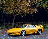 AUT 25 RK0434 06
1997 Lotus Esprit V8 Yellow Side 3/4 View On Pavement By Tree