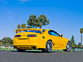 AUT 25 RK1436 01
1998 Toyota Supra Custom Yellow 3/4 Rear View On Pavement Blue Sky