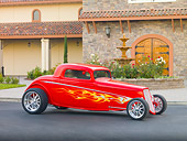 AUT 26 RK2848 01
1933 Ford Hi-Boy Coupe Hot Rod Red 3/4 Front View On Pavement By Building
