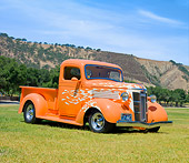 AUT 26 RK3045 01
1937 GMC Pickup Truck Orange With White Flames 3/4 Front View On Grass By Hills