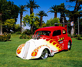 AUT 26 RK0580 02
1948 Ford Anglia Coupe Red With Flames 3/4 Front View On Grass By Trees