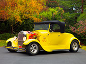 AUT 26 RK1214 01
1929 Ford Hot Rod Yellow Convertible 3/4 Front View On Pavement By Trees
