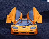 AUT 28 RK0004 07
1996 McLaren F1 LM Orange Head On View With Doors Open On Coal Field