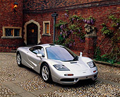 AUT 28 RK0029 01
McLaren F1 Silver 3/4 Front View On Stone Pavement By Brick House