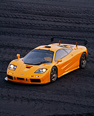AUT 28 RK0050 03
1996 McLaren F1 LM Orange Overhead 3/4 Front On Black Coal Field Headlights On