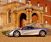 AUT 28 RK0067 14
McLaren F1 Silver 3/4 Front View On Gravel By Building And Steps