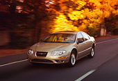 AUT 29 RK0150 07
1999 Chrysler 300M Champagne In Motion 3/4 Front View On Road By Trees
