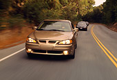 AUT 29 RK0446 01
1999 Pontiac Grand Am Gold 3/4 Front View On Road In Motion