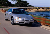 AUT 29 RK0488 03
2001 Oldsmobile Aurora V8 Silver 3/4 Front View On Road In Motion By Water
