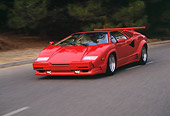AUT 29 RK0527 05
1989 Lamborghini Countach 25th Anniversary Edition Red 3/4 Front View On Road In Motion
