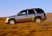 AUT 29 RK0580 04
2002 Chevy Trailblazer LTZ 4WD Pewter Profile On Road In Motion Dry Grass Blue Sky