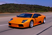 AUT 29 RK0611 17
2002 Lamborghini Murcielago Orange 3/4 Front View On Road In Motion By Trees And Hills